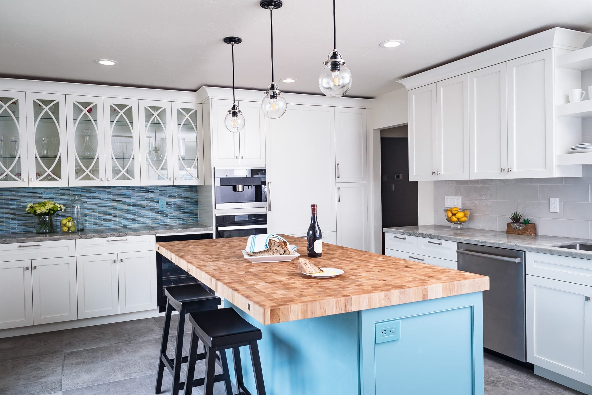 Butcher block and blue island with white cabinets kitchen design
