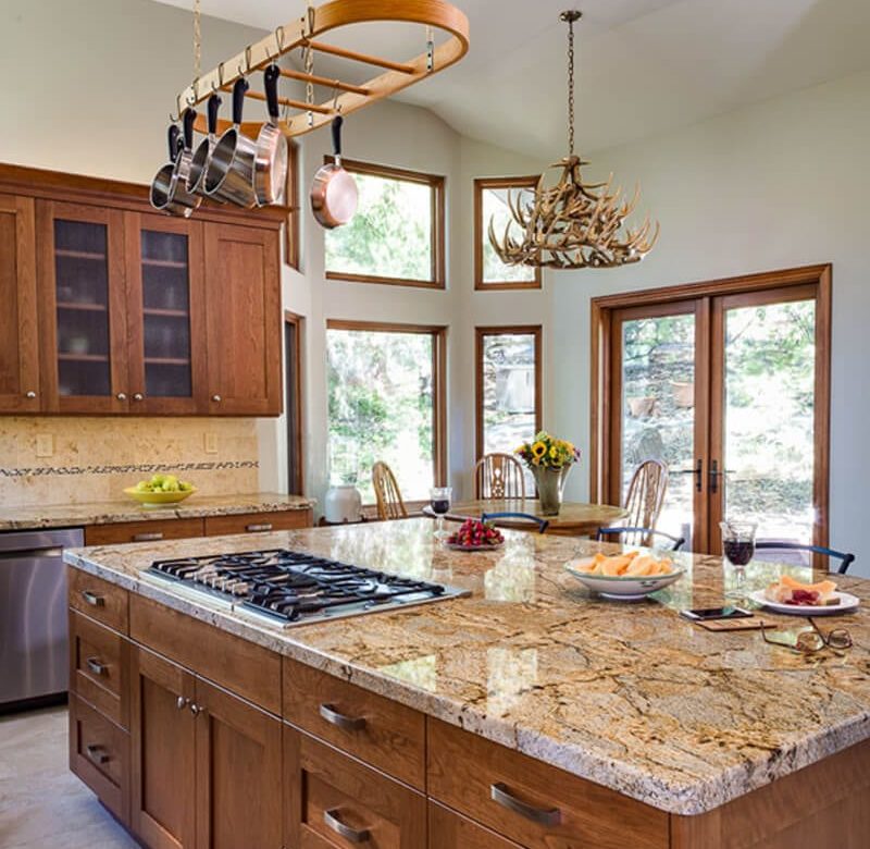 kitchen island with cooktop and chandelier