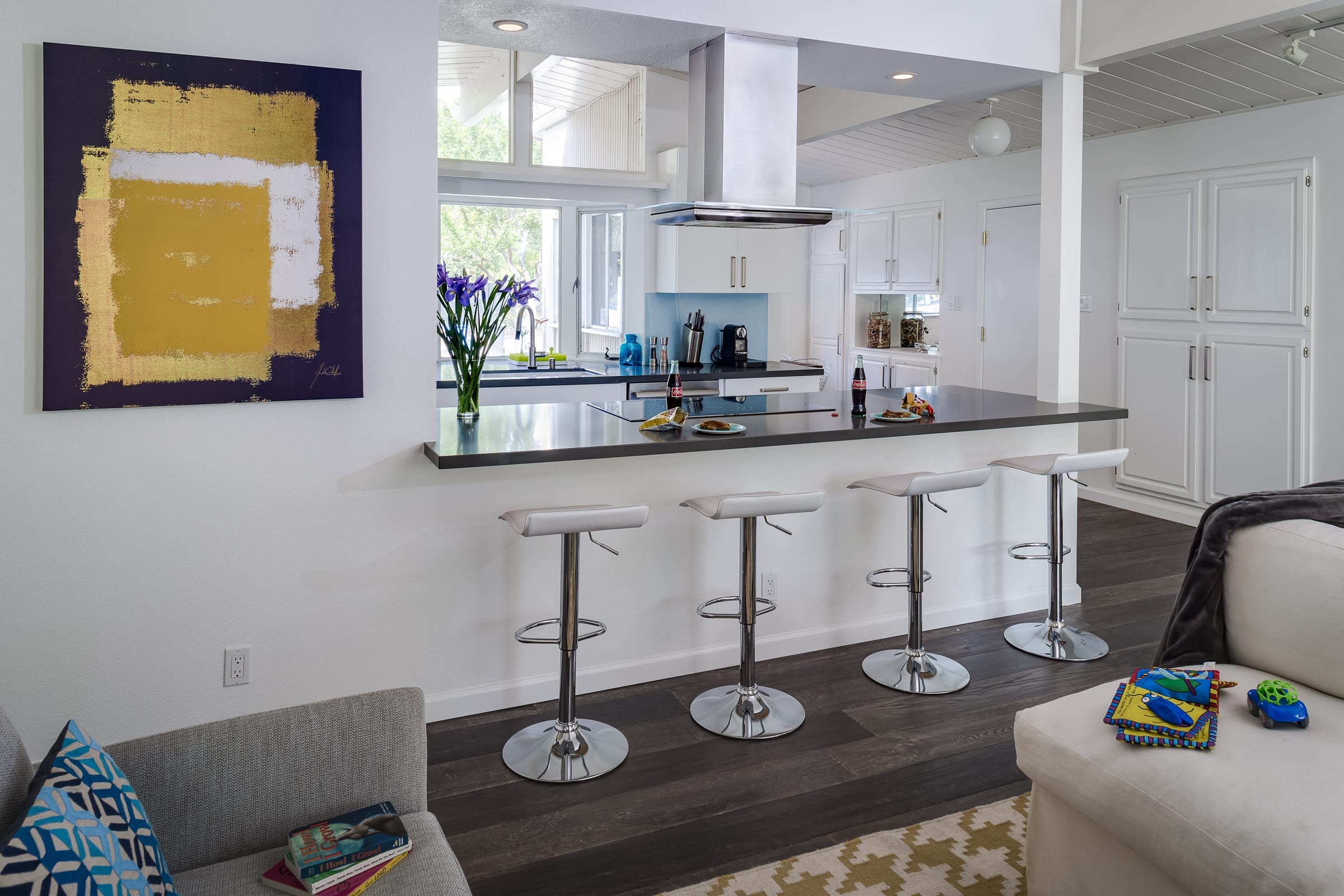Eichler Kitchen Peninsula with Counter Seating black countertops and white stool seating for 4