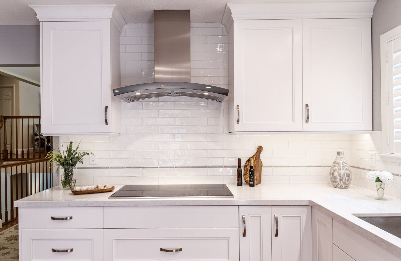 range and hood set against white subway tile in kitchen remodel