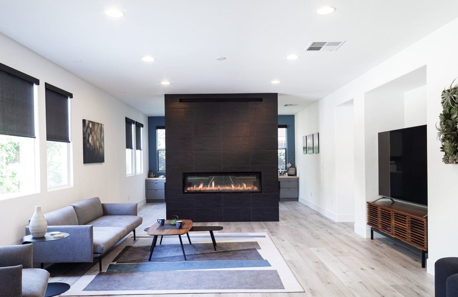 Living room remodel after picture of black linear fireplace