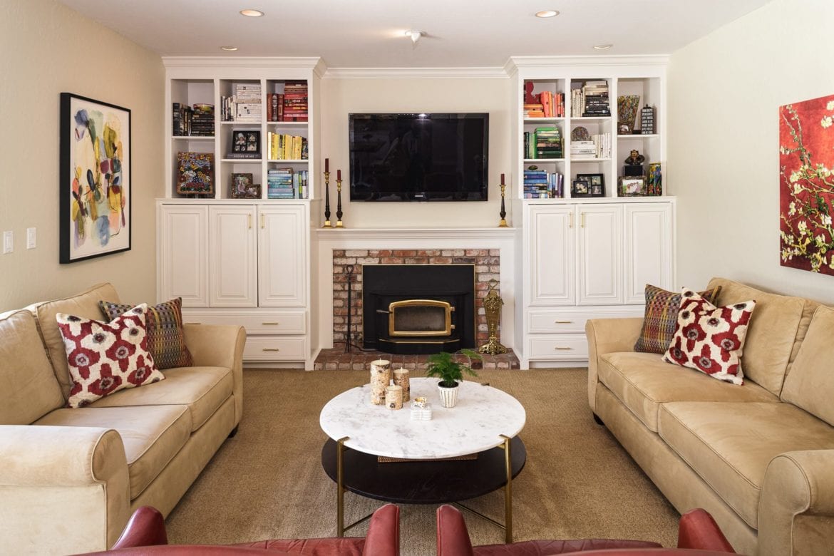 living room remodel with white built-ins and fireplace