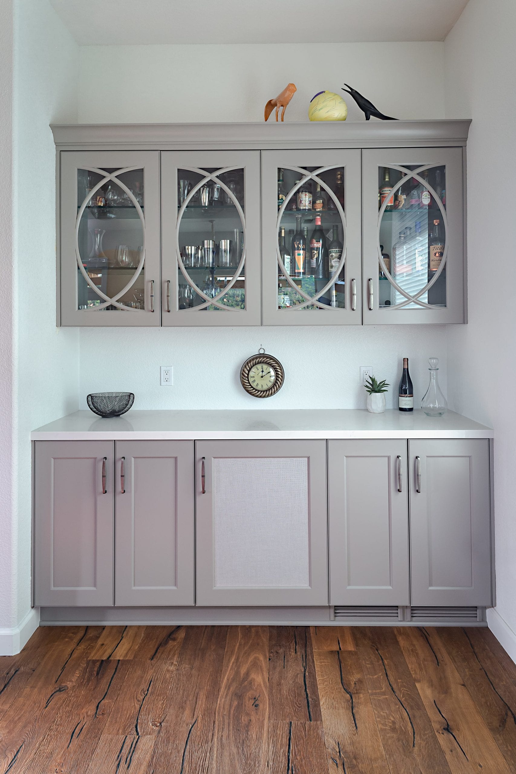 Taupe painted cabinets with glass at bar