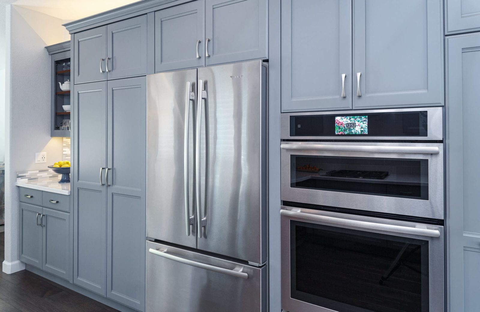 kitchen remodel with grey cabinets stainless steel appliances hardwood floors