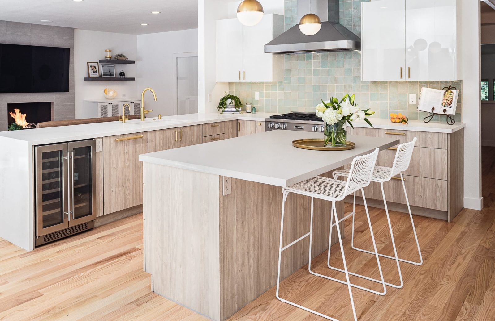 Kitchen with center island, peninsula with wine fridge, brass accents