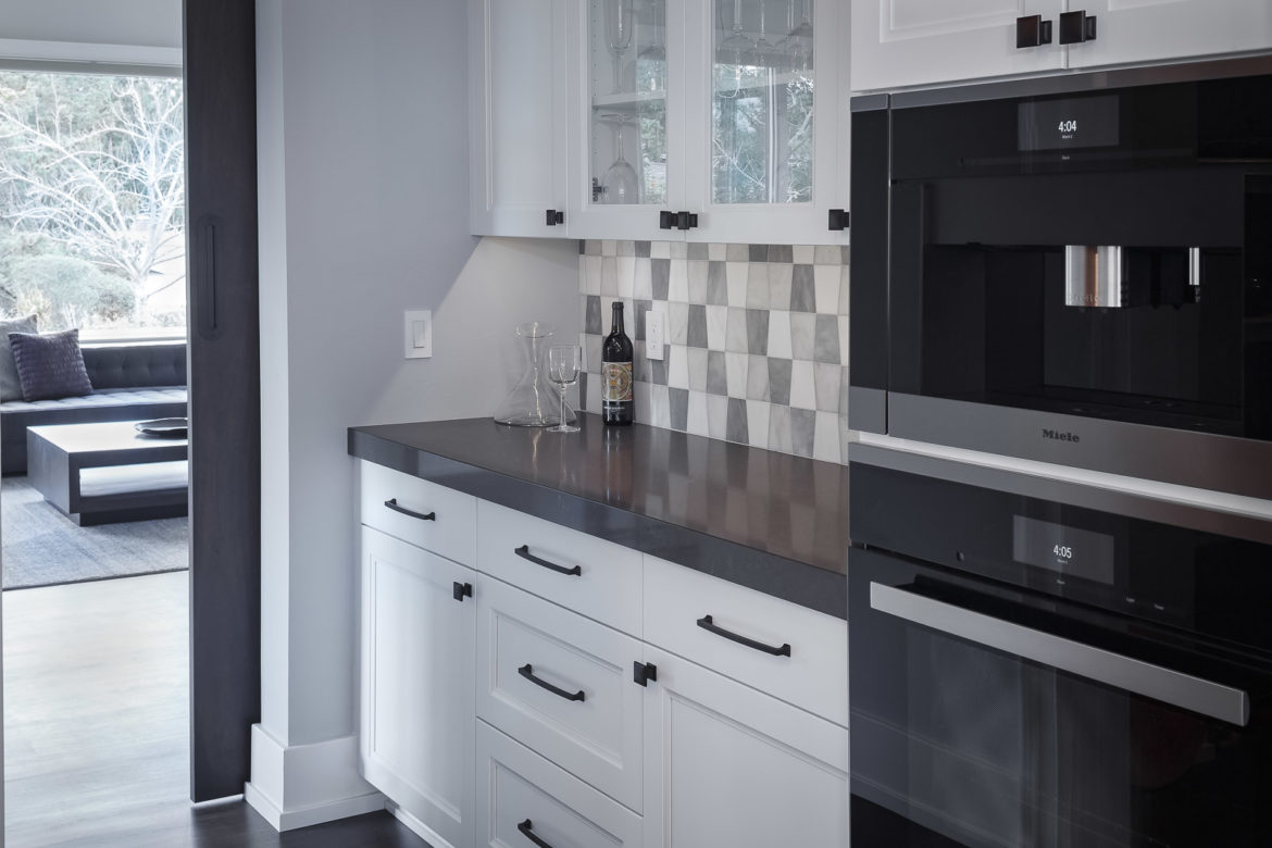 drybar with Crystal cabinets with glass doors and double ovens