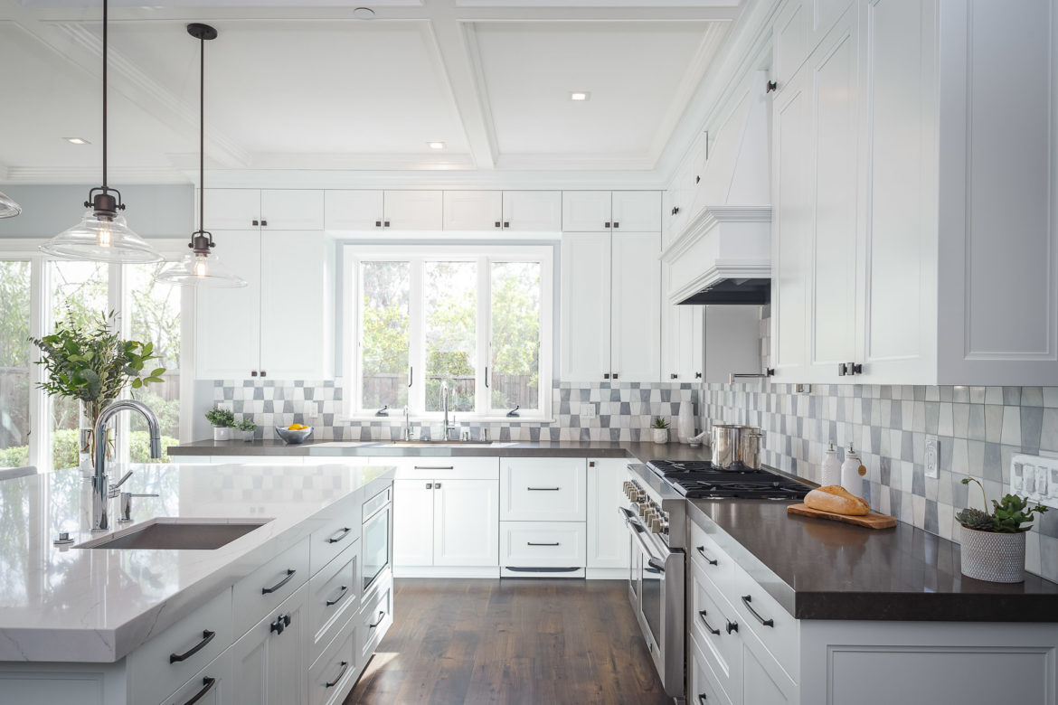 white cabinets, quartz countertops, tile backsplash, large island, white painted kitchen cabinets