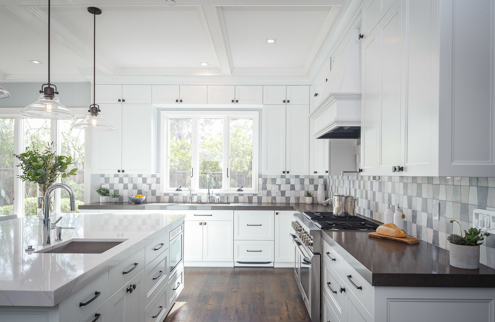 white cabinets, quartz countertops, tile backsplash, large island, white painted kitchen cabinets