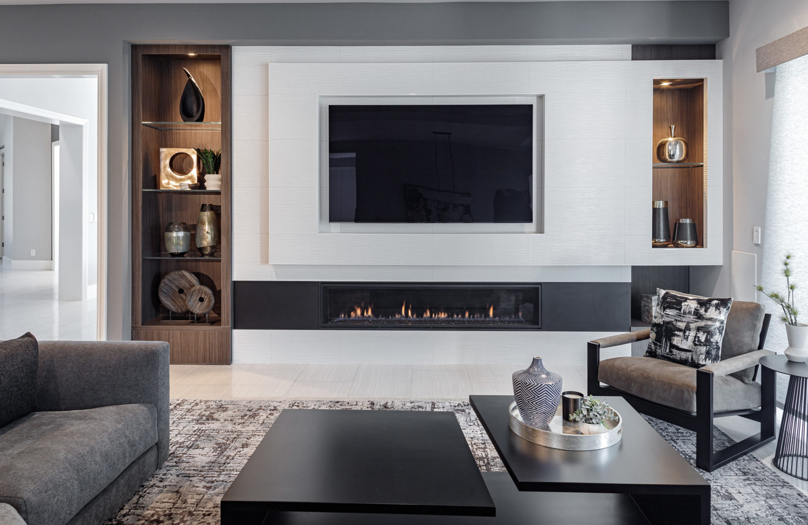 Family room with linear fireplace, asymmetrical shelves