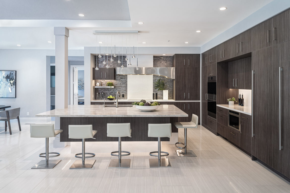 modern Kitchen with floating dark wood huge island with white chair seating on 3 sides