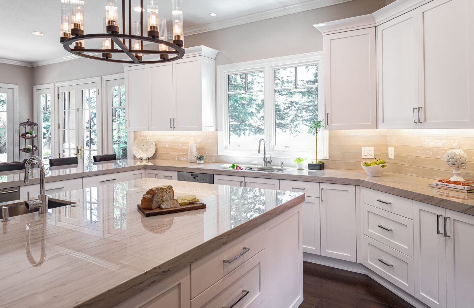 Qartzite countertops and white cabinets on a large island