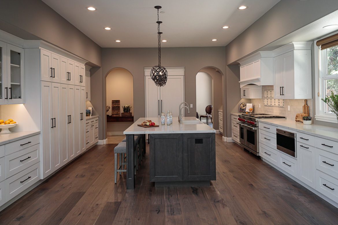 White kitchen,large island, island pendants