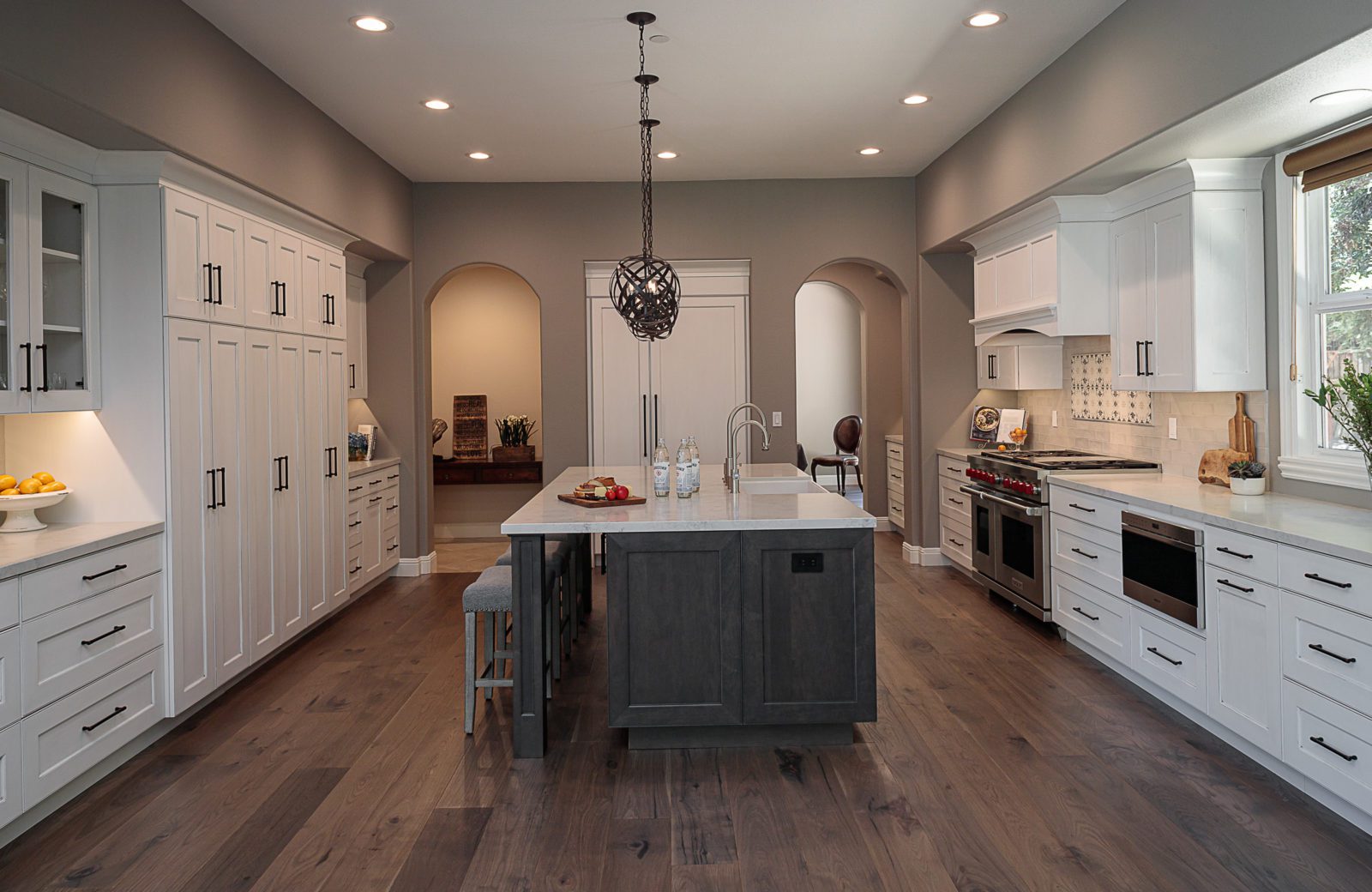 White kitchen,large island, island pendants