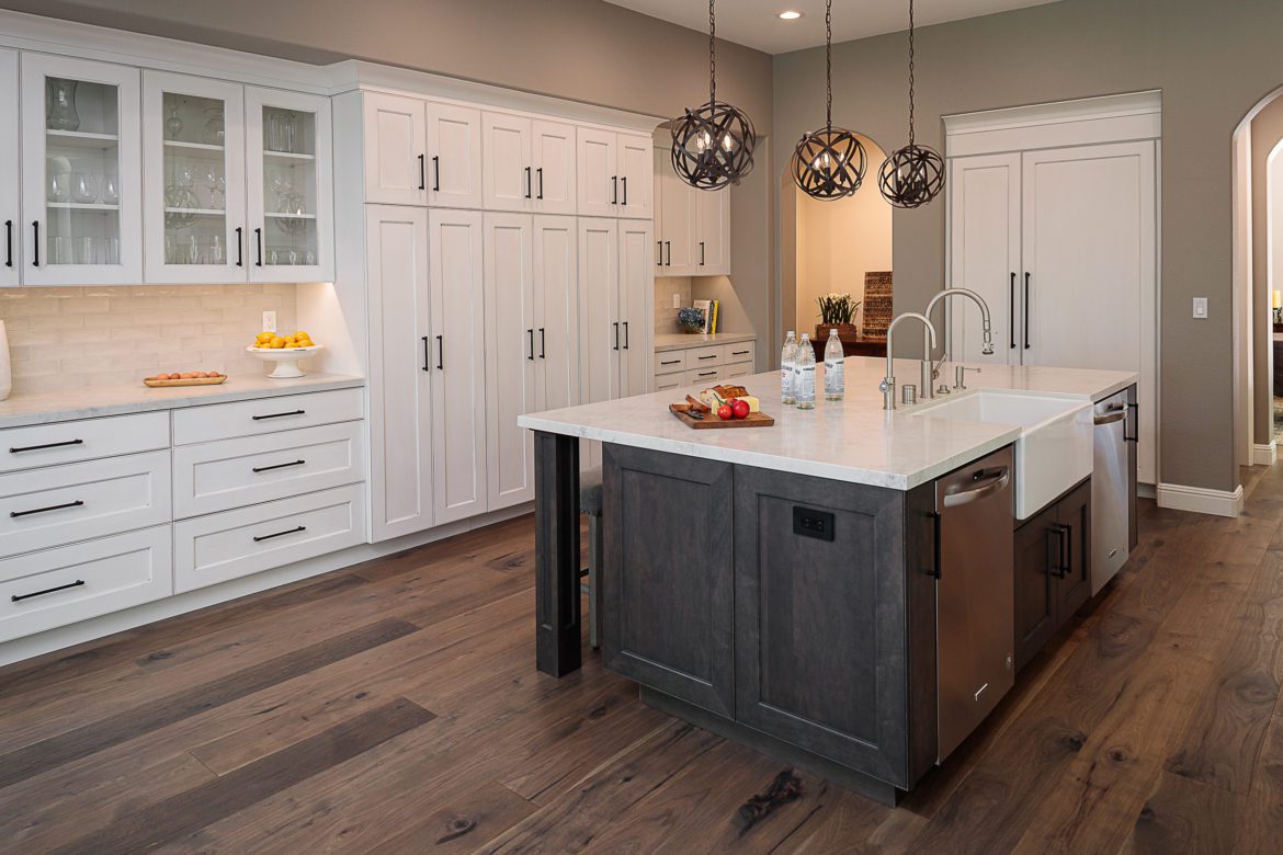 white cabinets, large island, wood floors