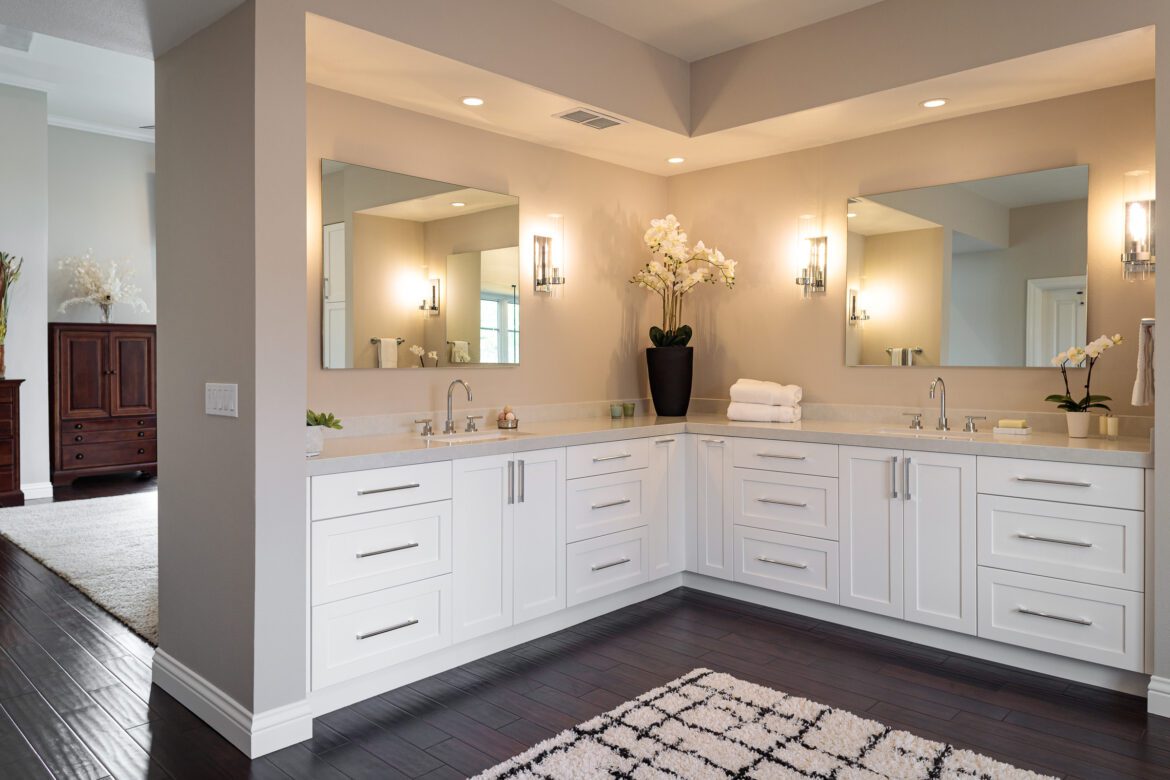 after Large primary bathroom remodel l-shaped vanity with white cabinets