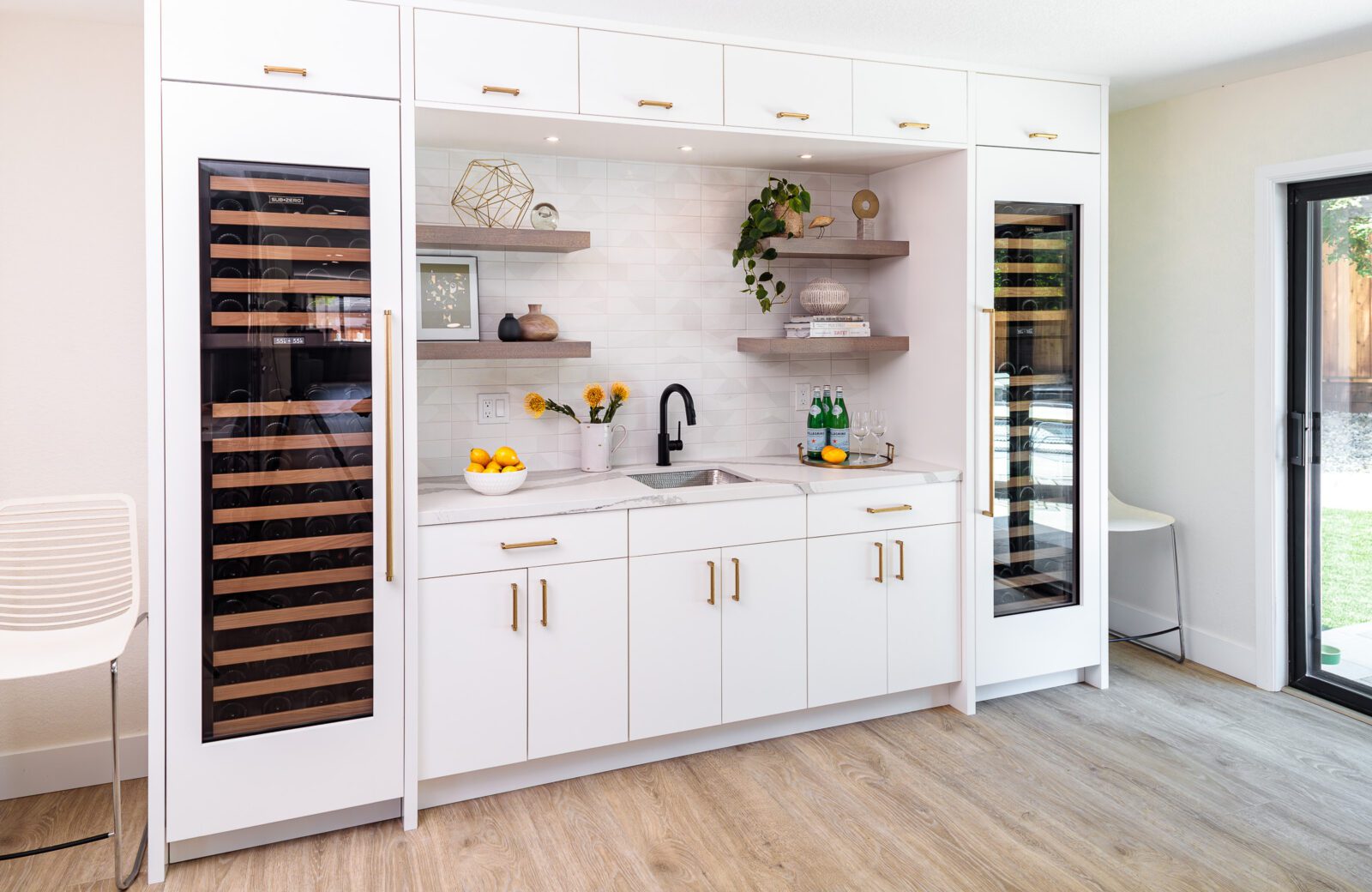 2 tall Miele wine refrigerators, white painted cabinets, wine bar, wood shelving