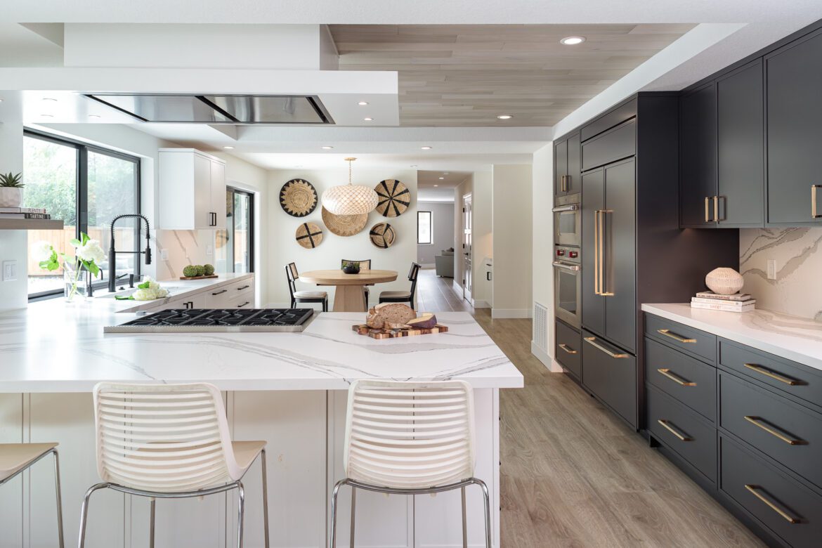 large kitchen with white and black cabinets, wood ceiling, LVP floors