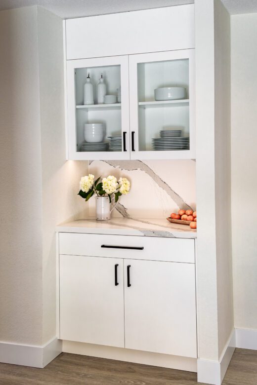 white painted Cystal cabinetry, glass doors, quartz countertops