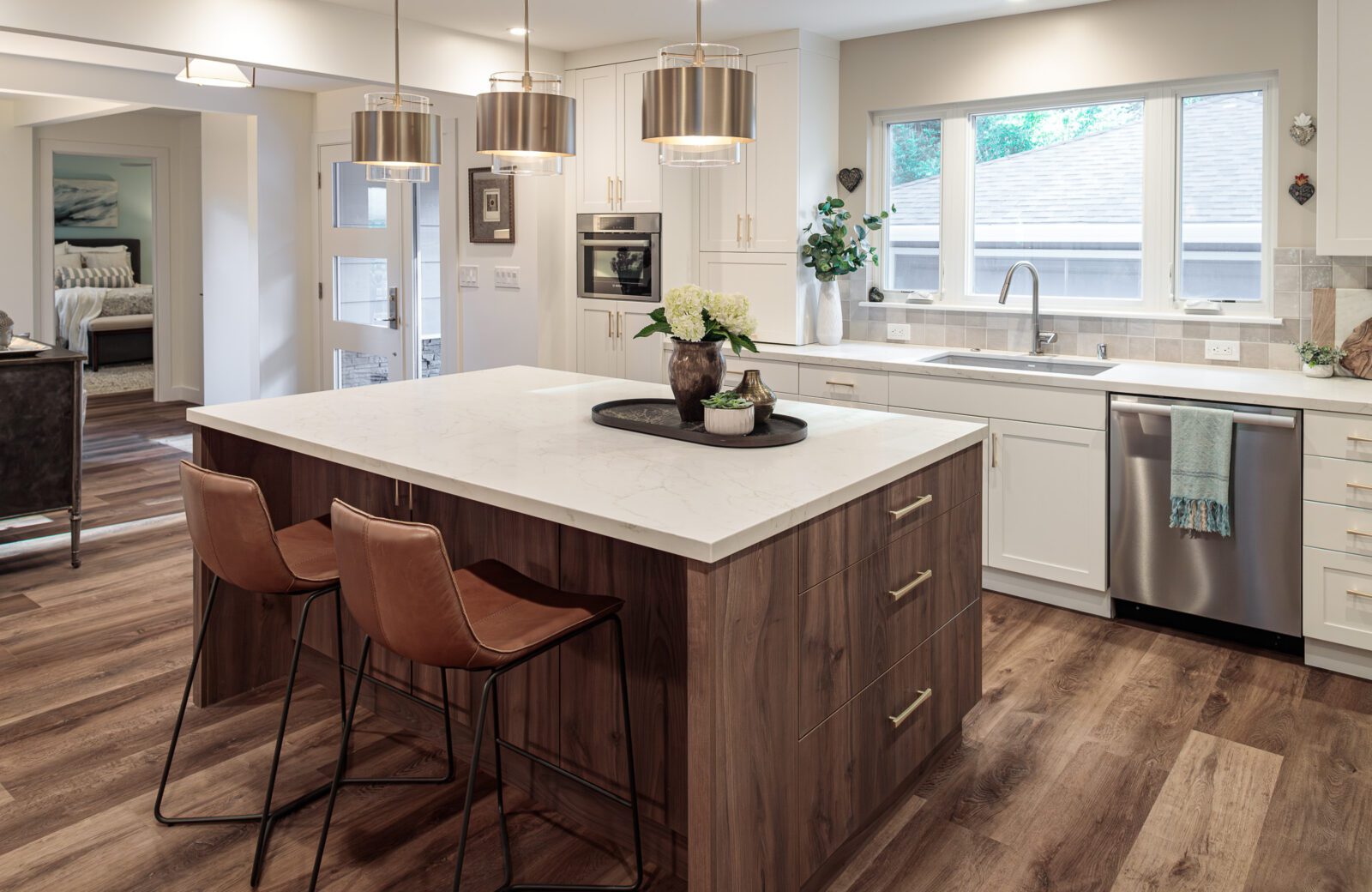 2 leather chairs in linear style with white and wood kitchen island
