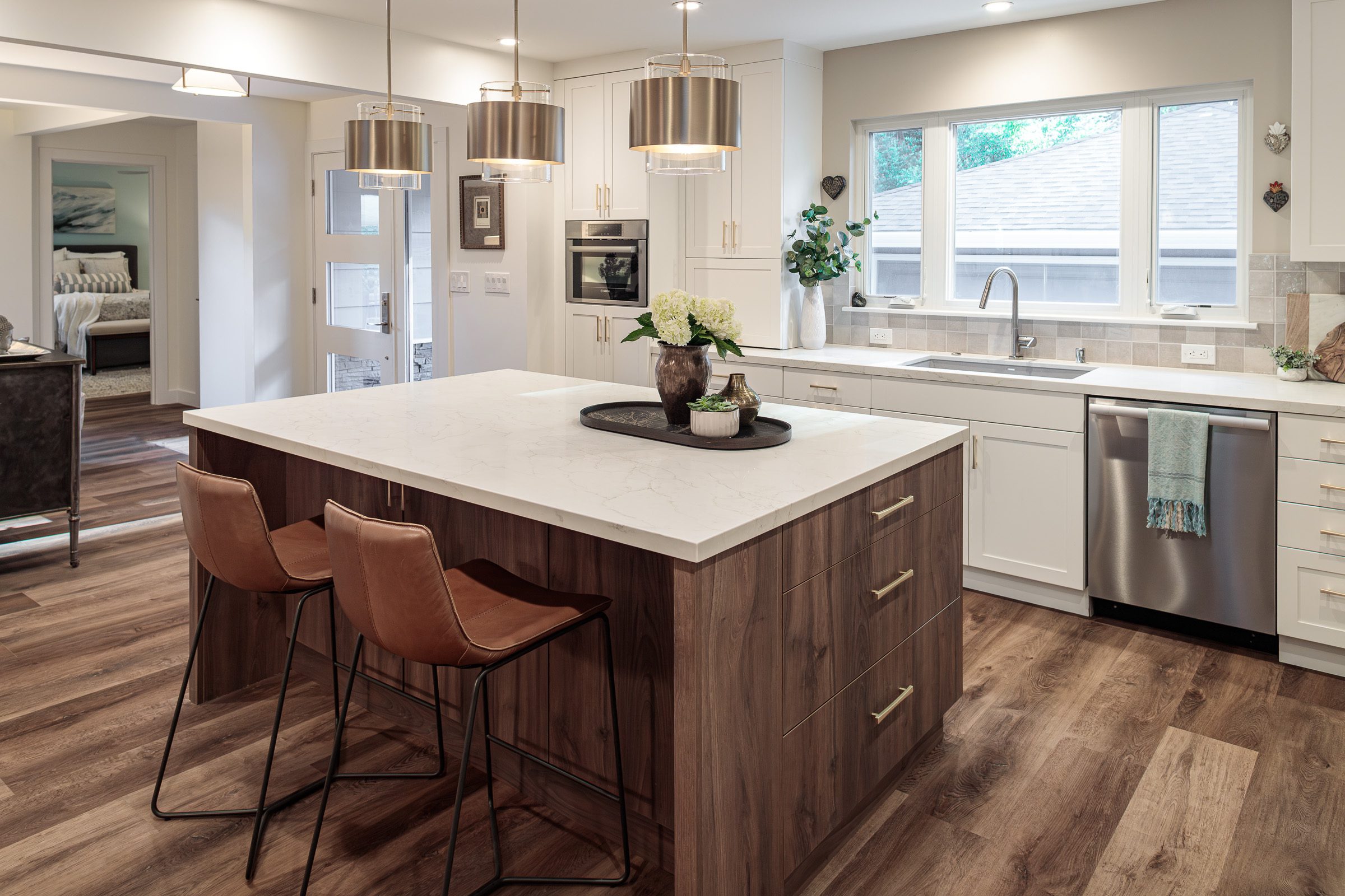 modern two tone kitchen wood island with space for seating white cabinets wood floor