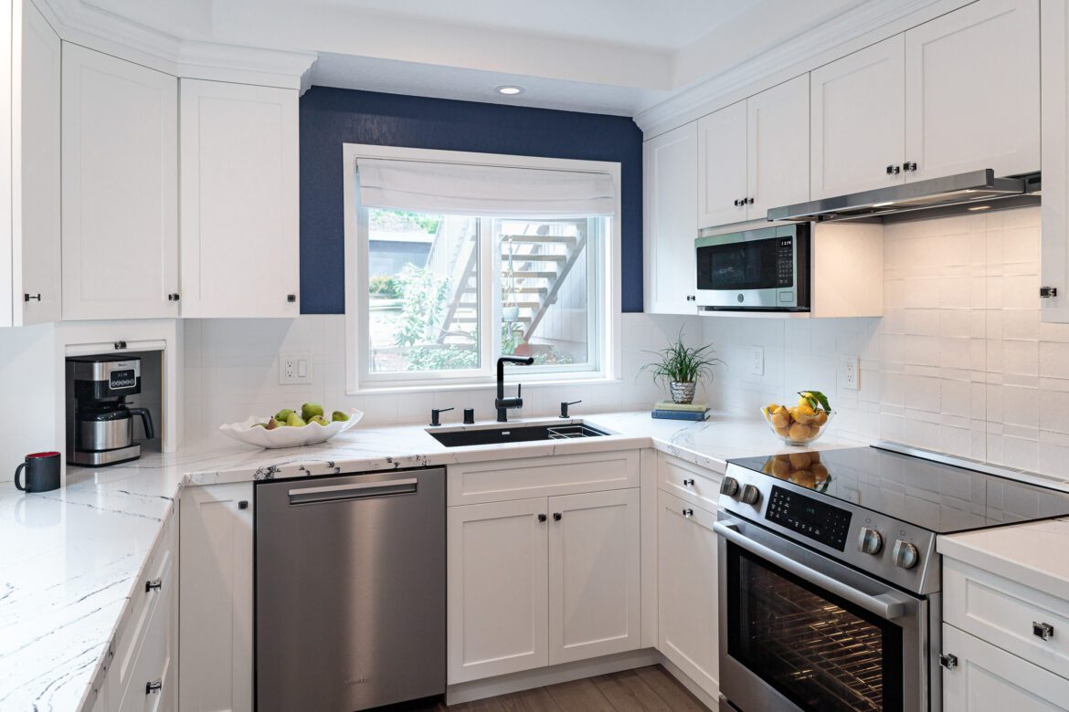 Blue and white kitchen with appliance garage