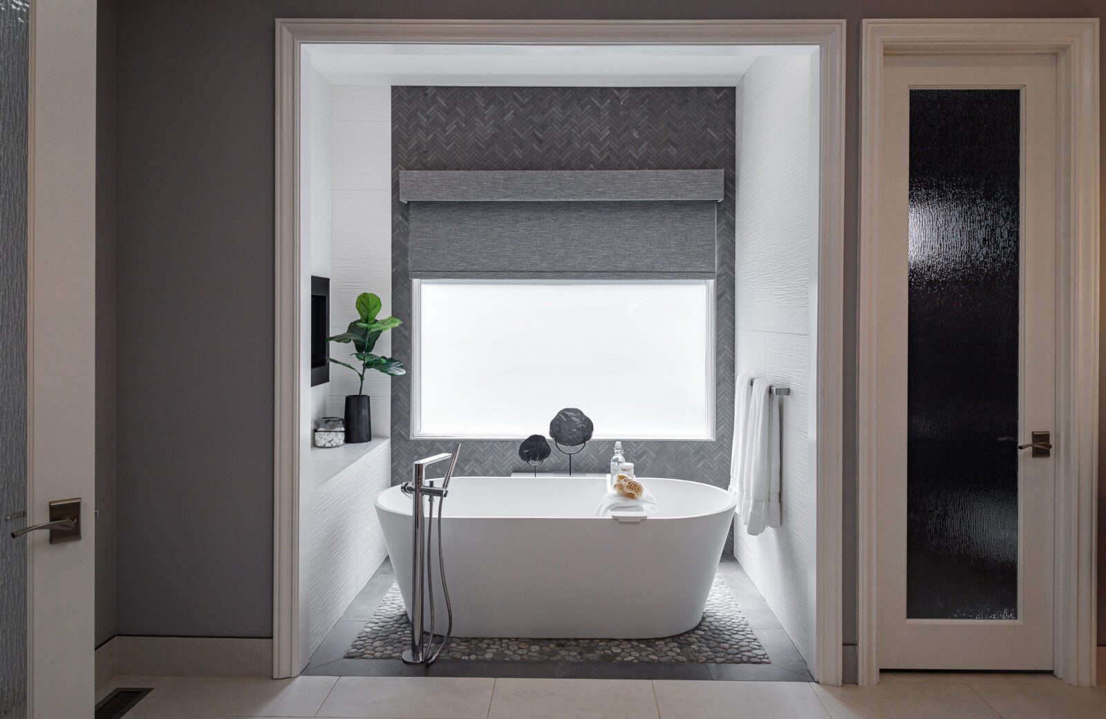 contemporary bathroom remodel Freestanding soaking tub, chevron tile wall, two sided fireplace