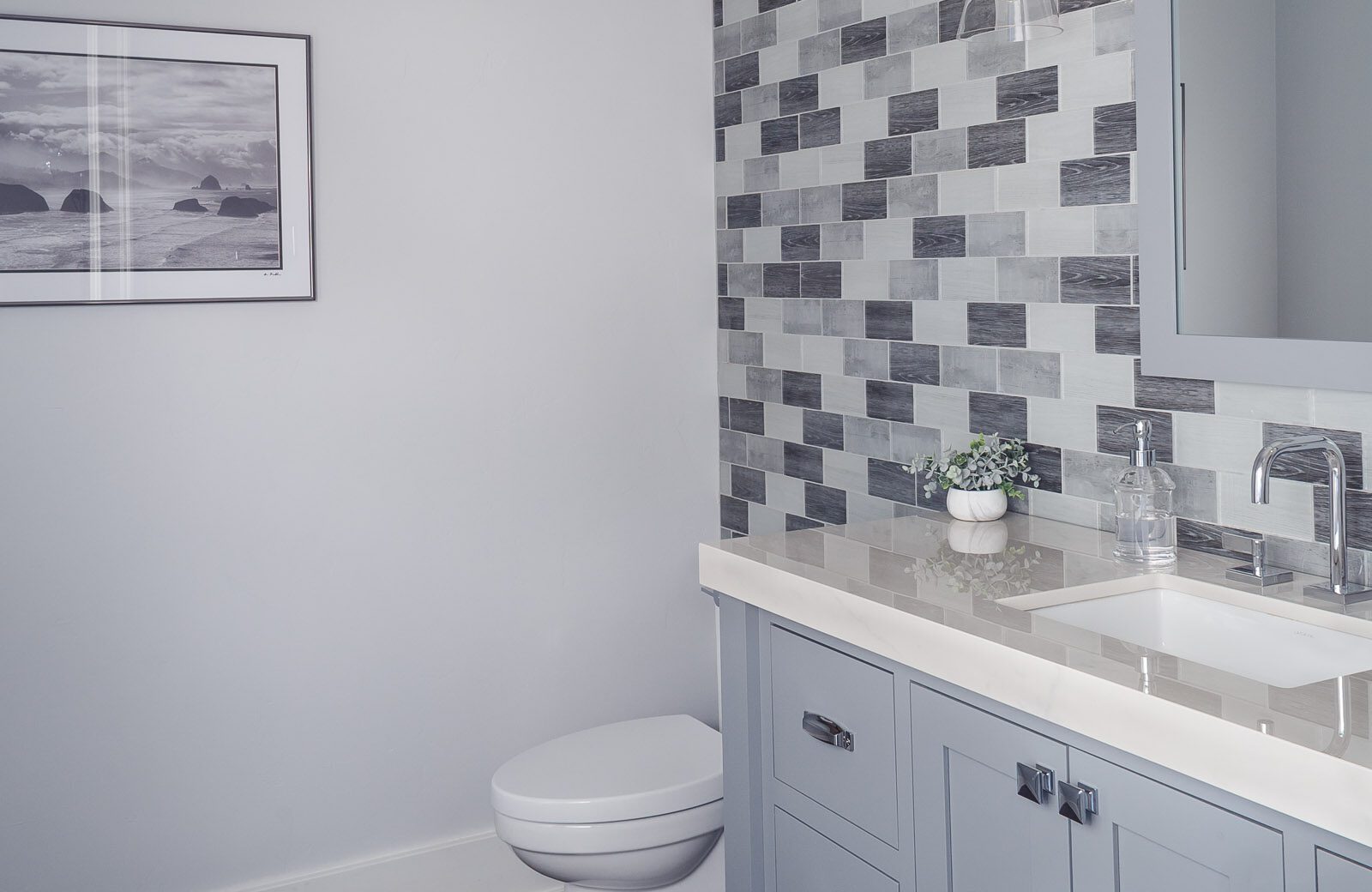 gray white Glass tile bathroom accent wall in powder room gray painted vanity
