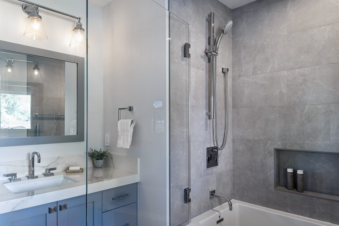 Neutral greige rectangle large format porcelain tile guest bathroom remodel