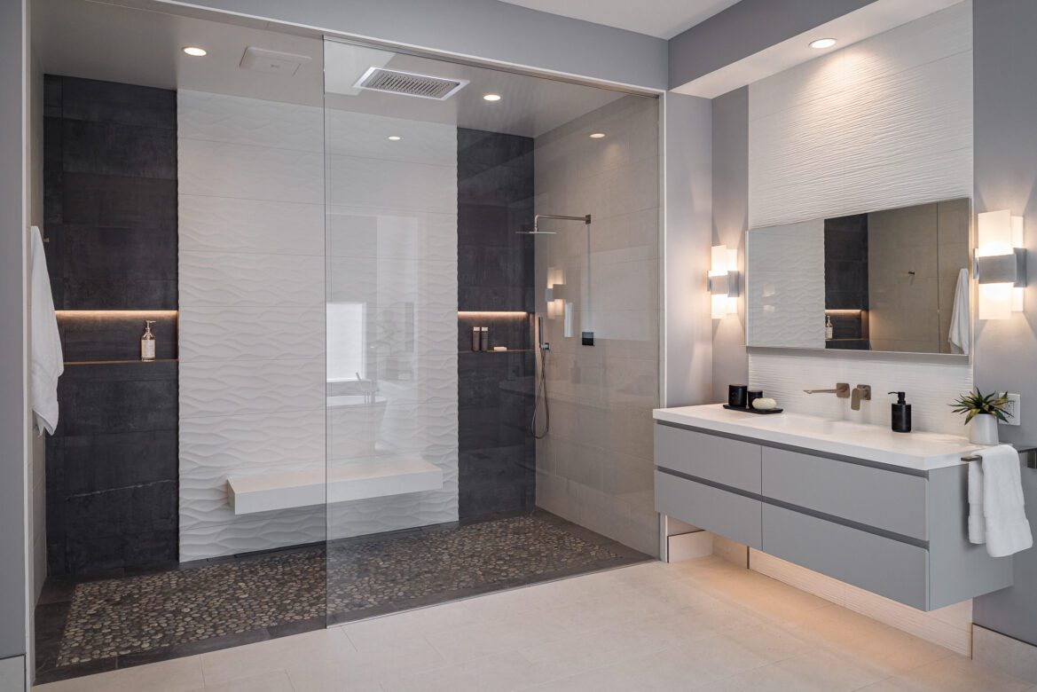 Primary bath remodel with floating bench, chromatherapy rain shower head, custom glass enclosure, lighted niches 3d white tile