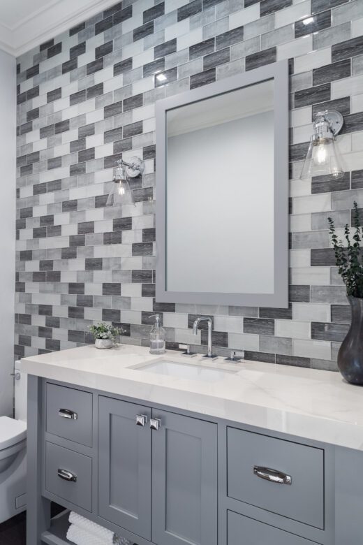 powder room remodel with gray white rectangle glass tile accent wall
