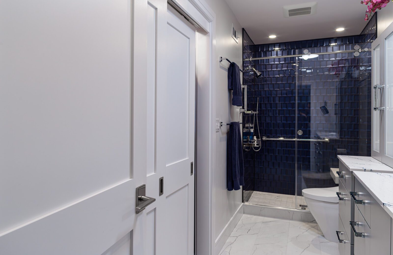 primary bathroom remodel, blue 3d tile shower walls, white closet doors, gray tile floors