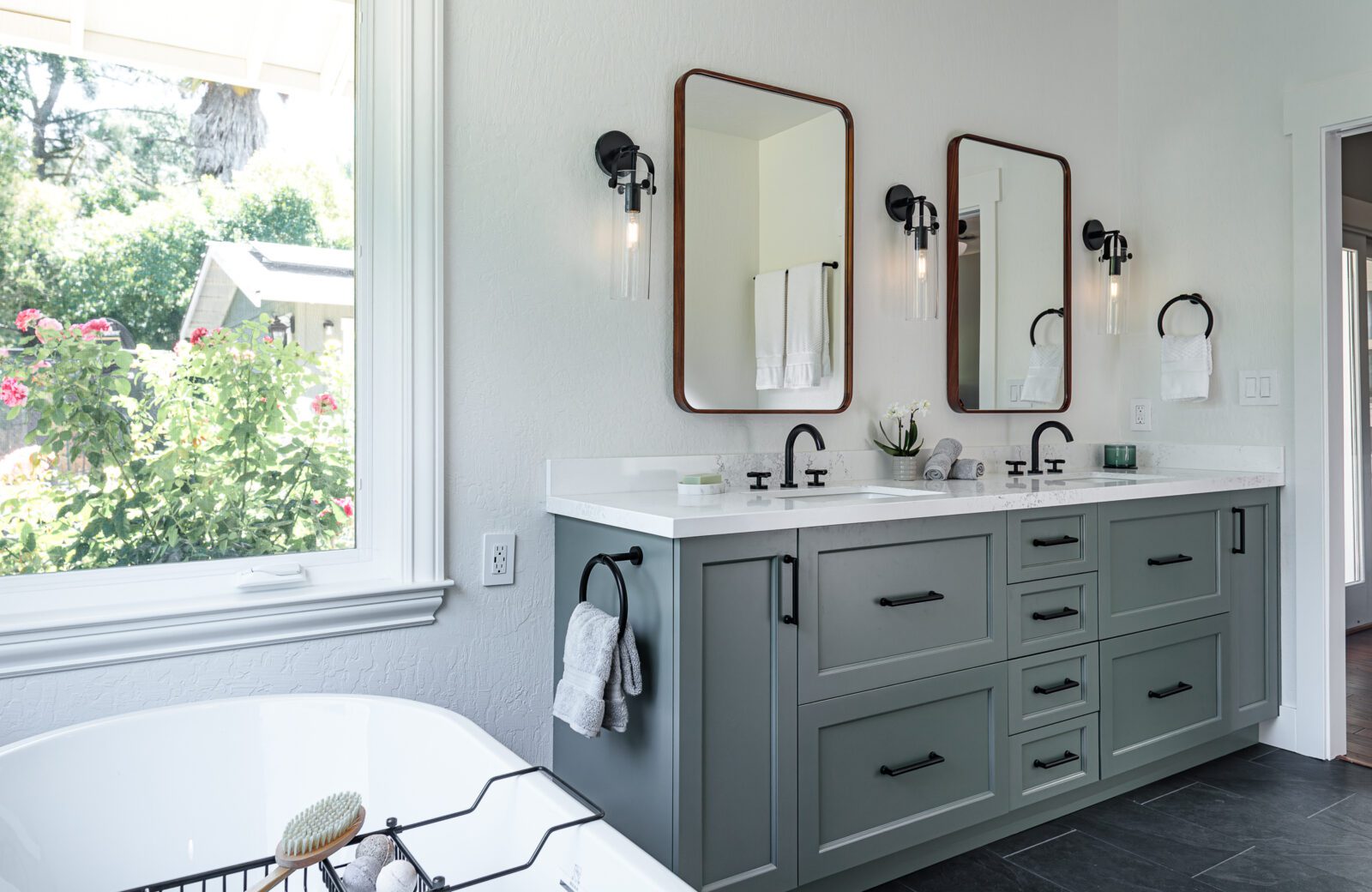primary bathroom remodel, Green double vanity, quartz countertops and freestanding white tub