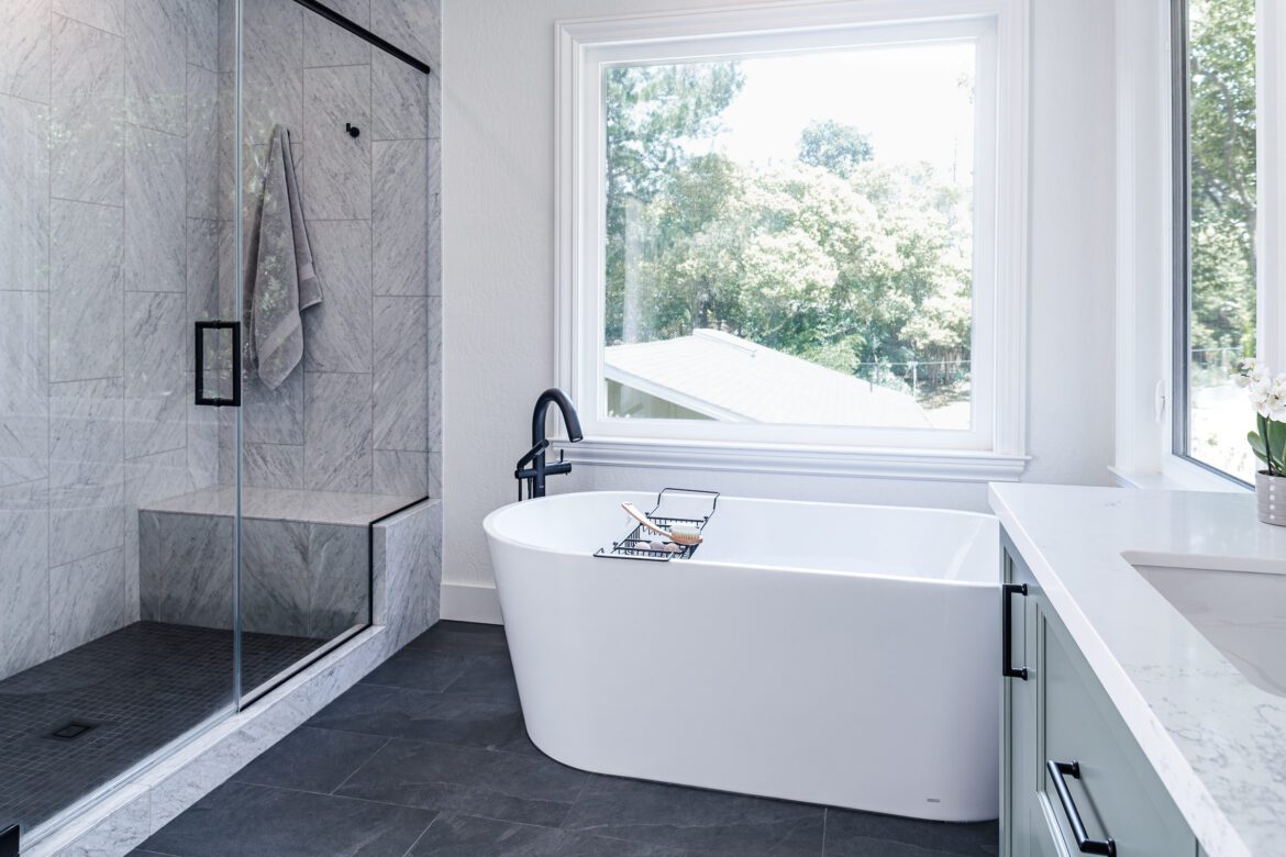Primary bathroom remodel, freestanding white tub, marble shower tile, slate floor
