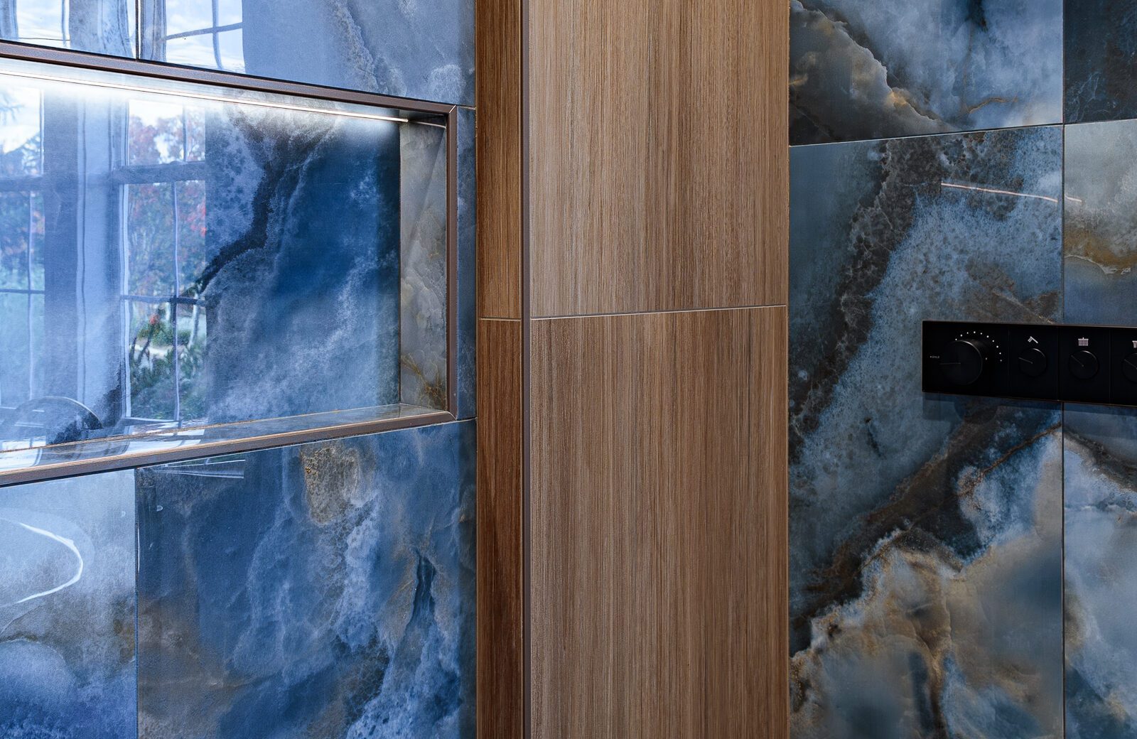 blue onyx large tile shower walls with bamboo tile accent and lighted niche