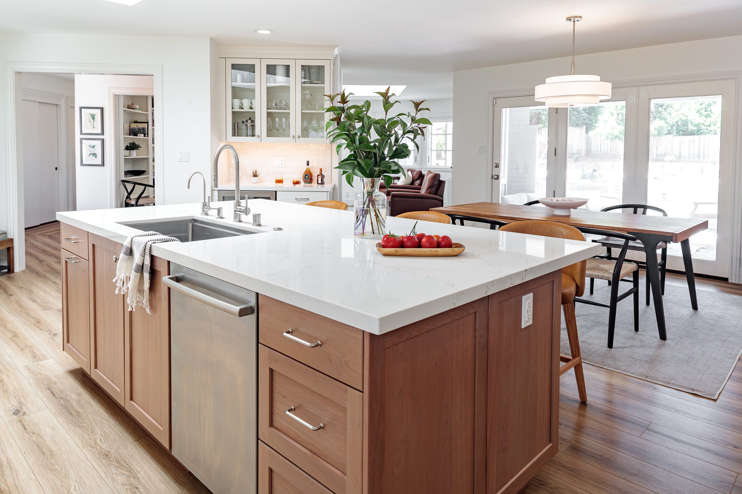 white kitchen remodel with double ovens and cooktop wood floors garden window