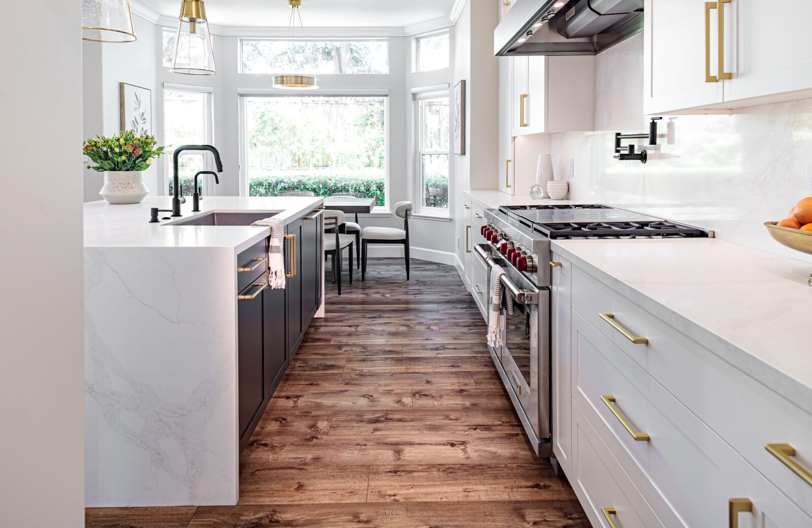 LVP flooring, waterfall countertop, wolf range