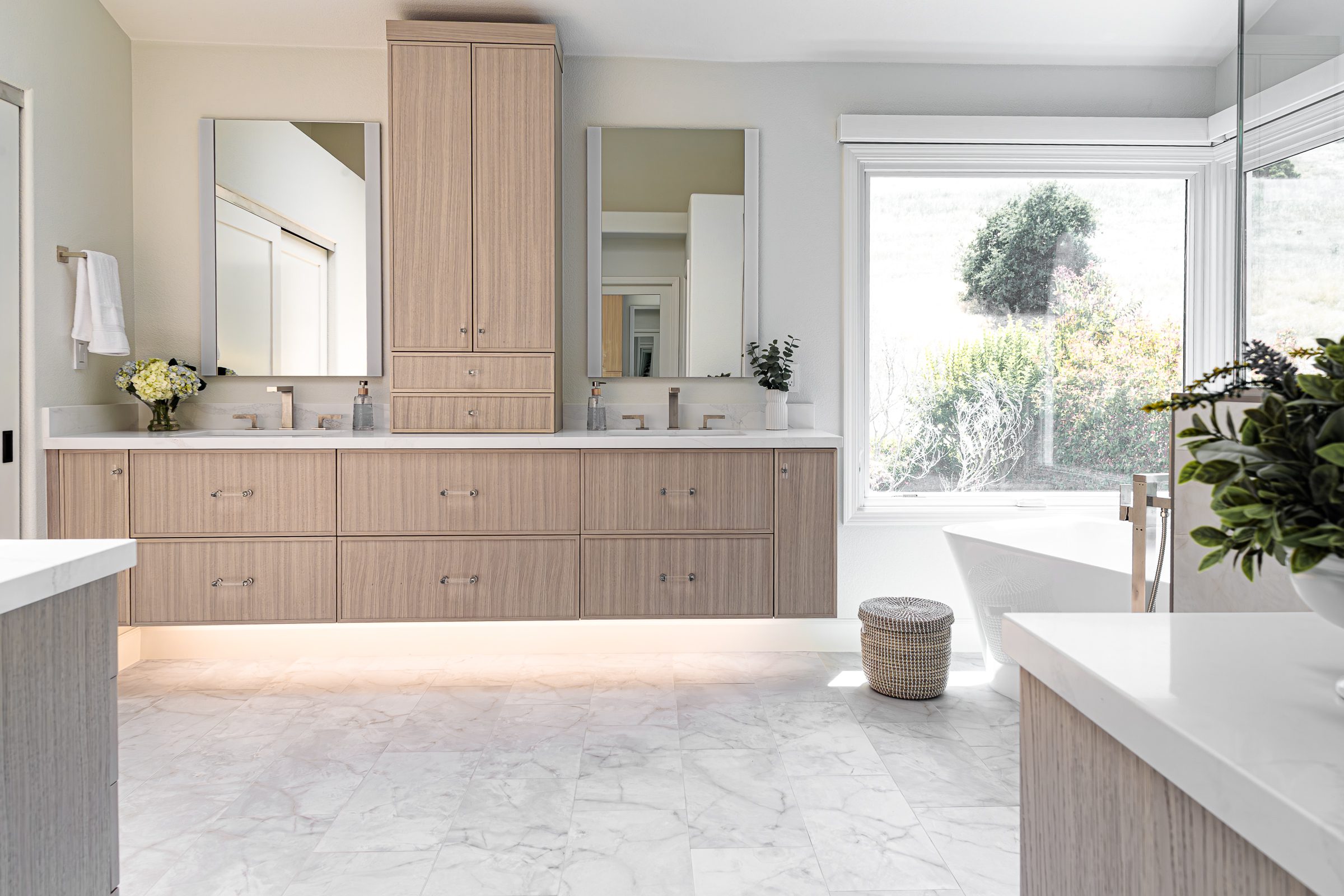 Danville, CA Primary bath remodel with floating vanity, light wood cabinets and lighted mirrors