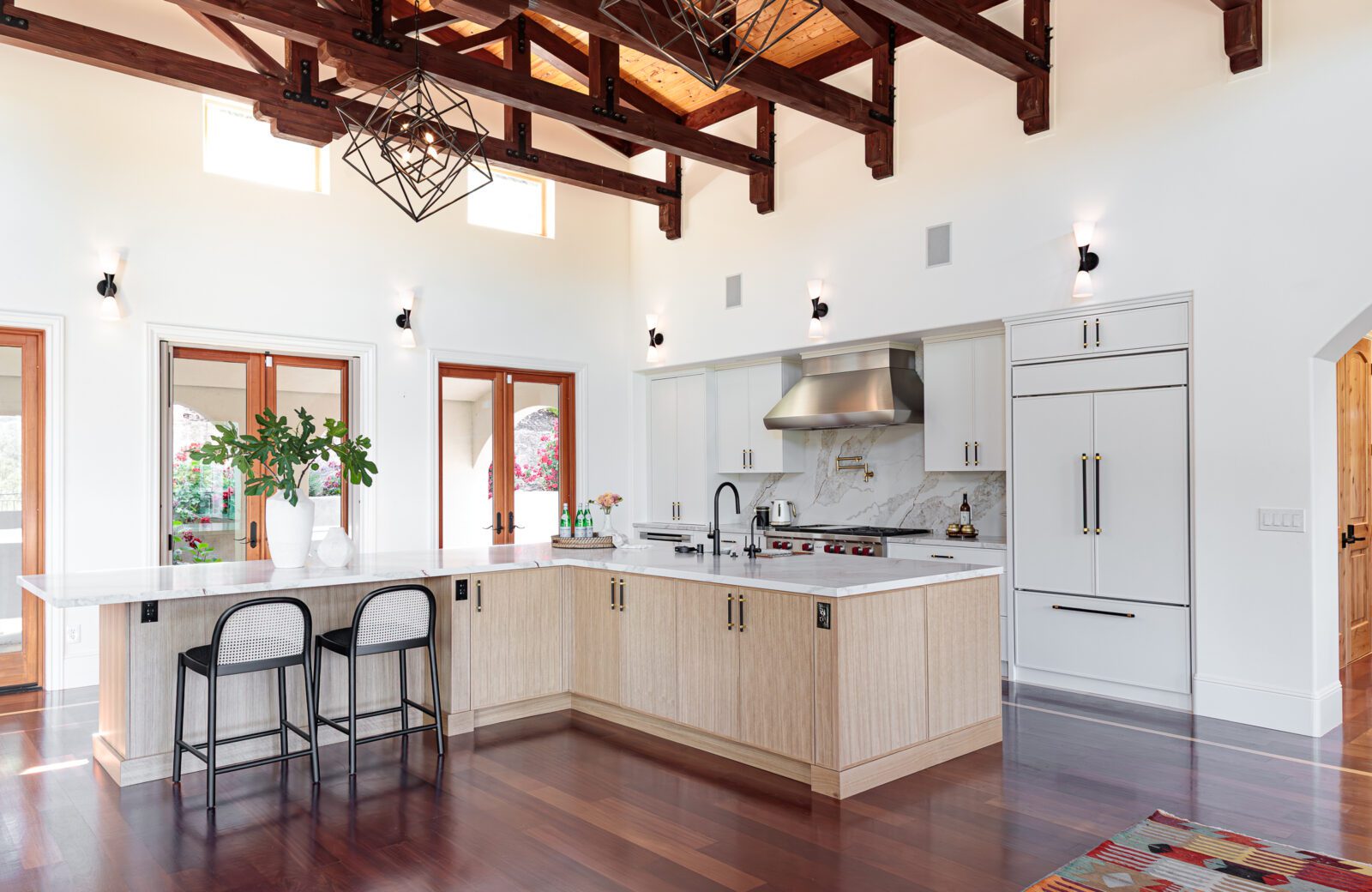 enormous counter height two seat island with linear seating two white chairs with backs
