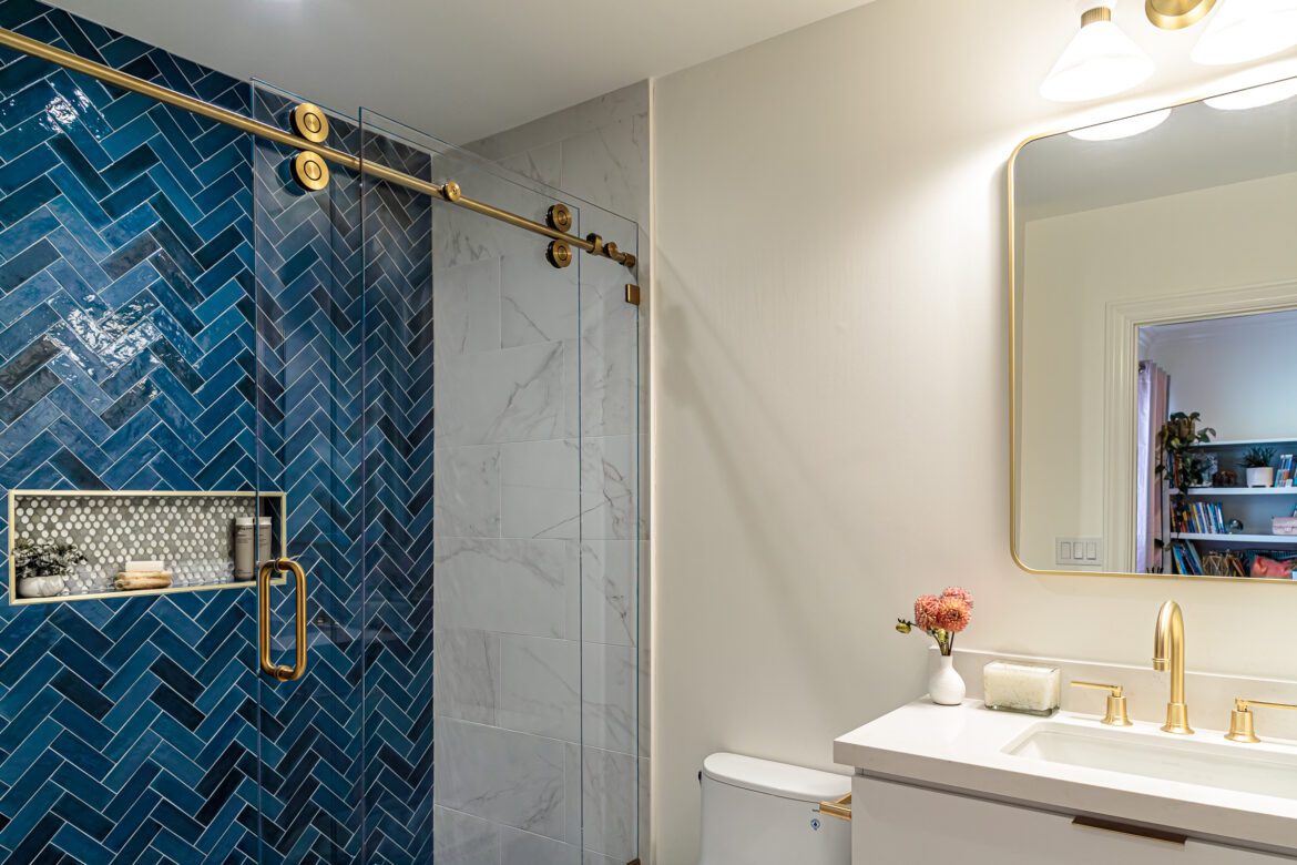 blue herringbone tile shower wall blue white bathroom remodel