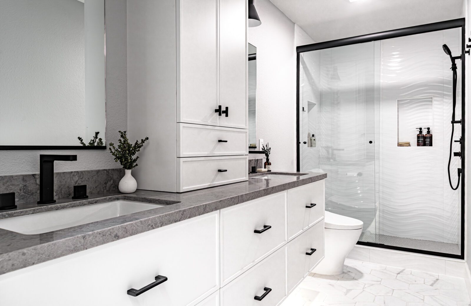 black and white hall bathroom with cabinet on countertop, double vanity
