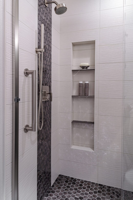guest bathroom remodel with shower niche, tile accents