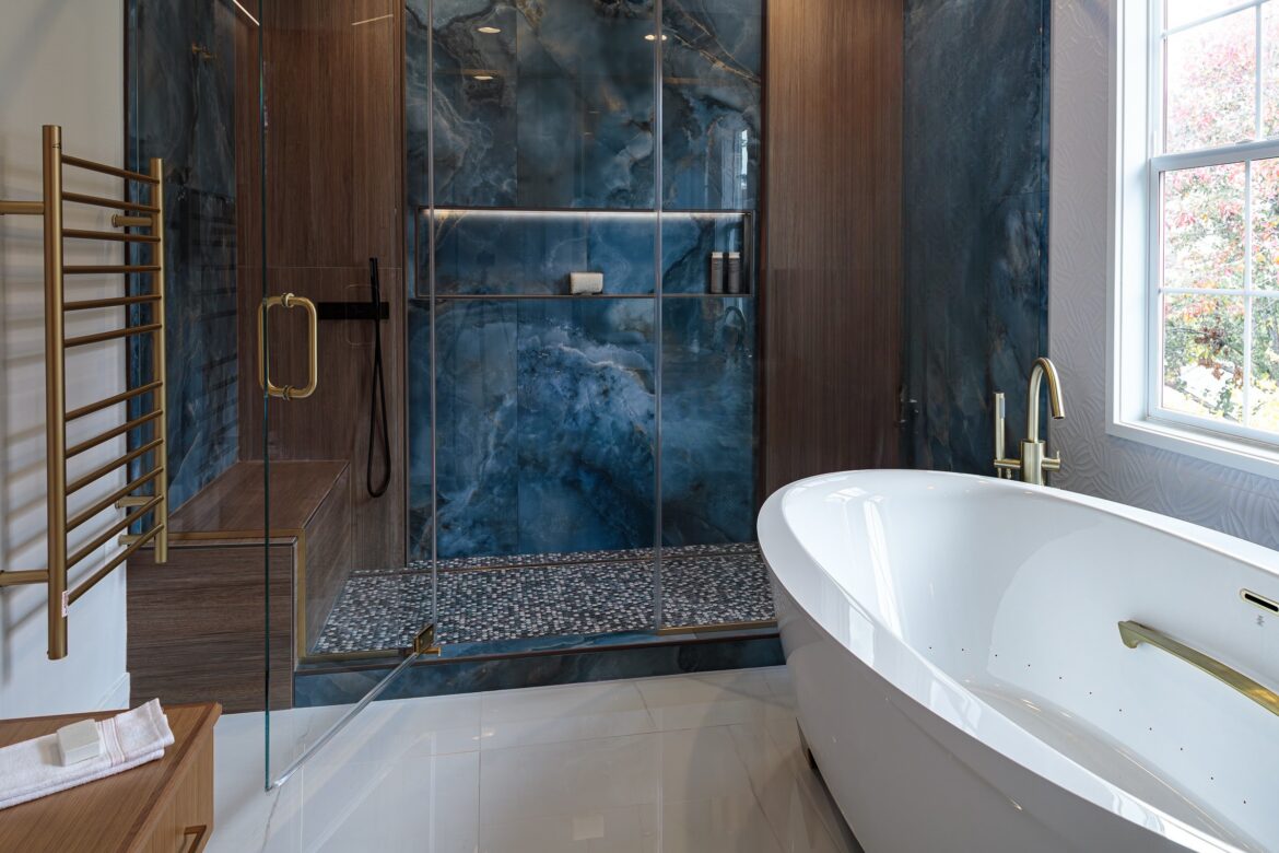 blue and tan tiled shower walls and freestanding jetted tub_cleanup