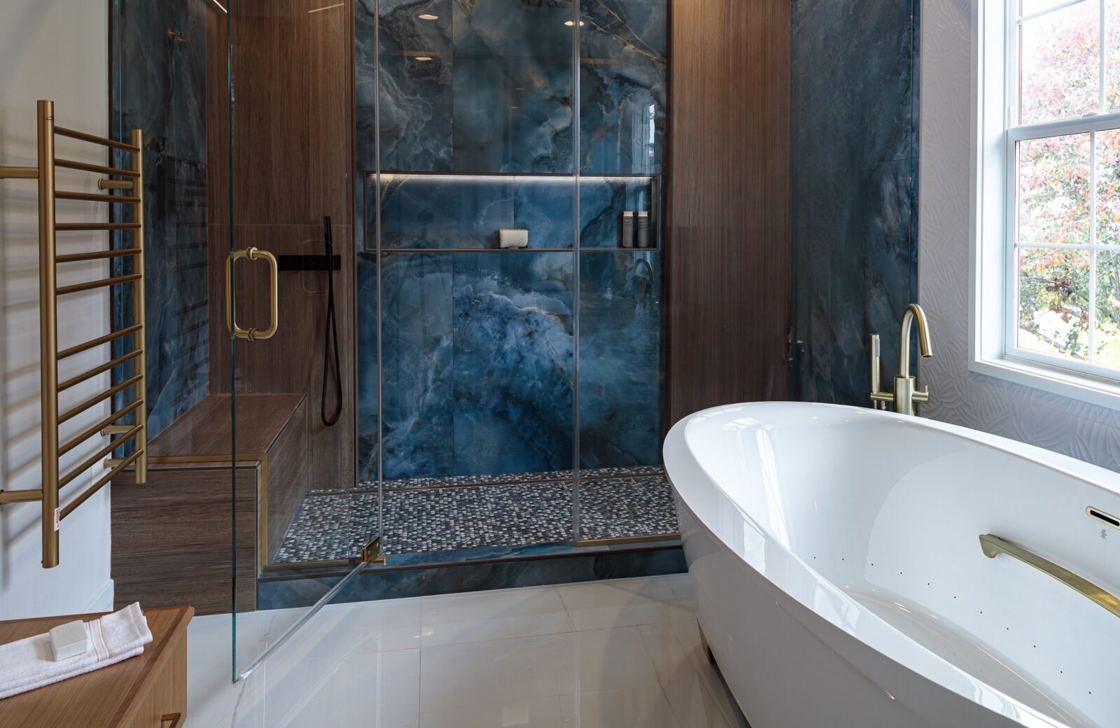 blue and tan tiled shower walls and freestanding jetted tub_cleanup