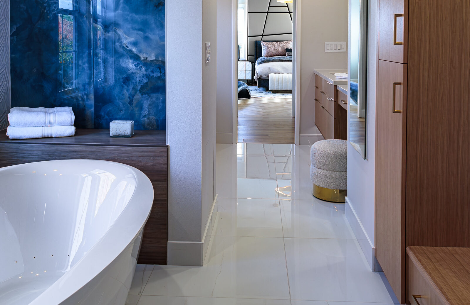 primary bathroom with large jetted soaking tub, blue wall tile, bench seating