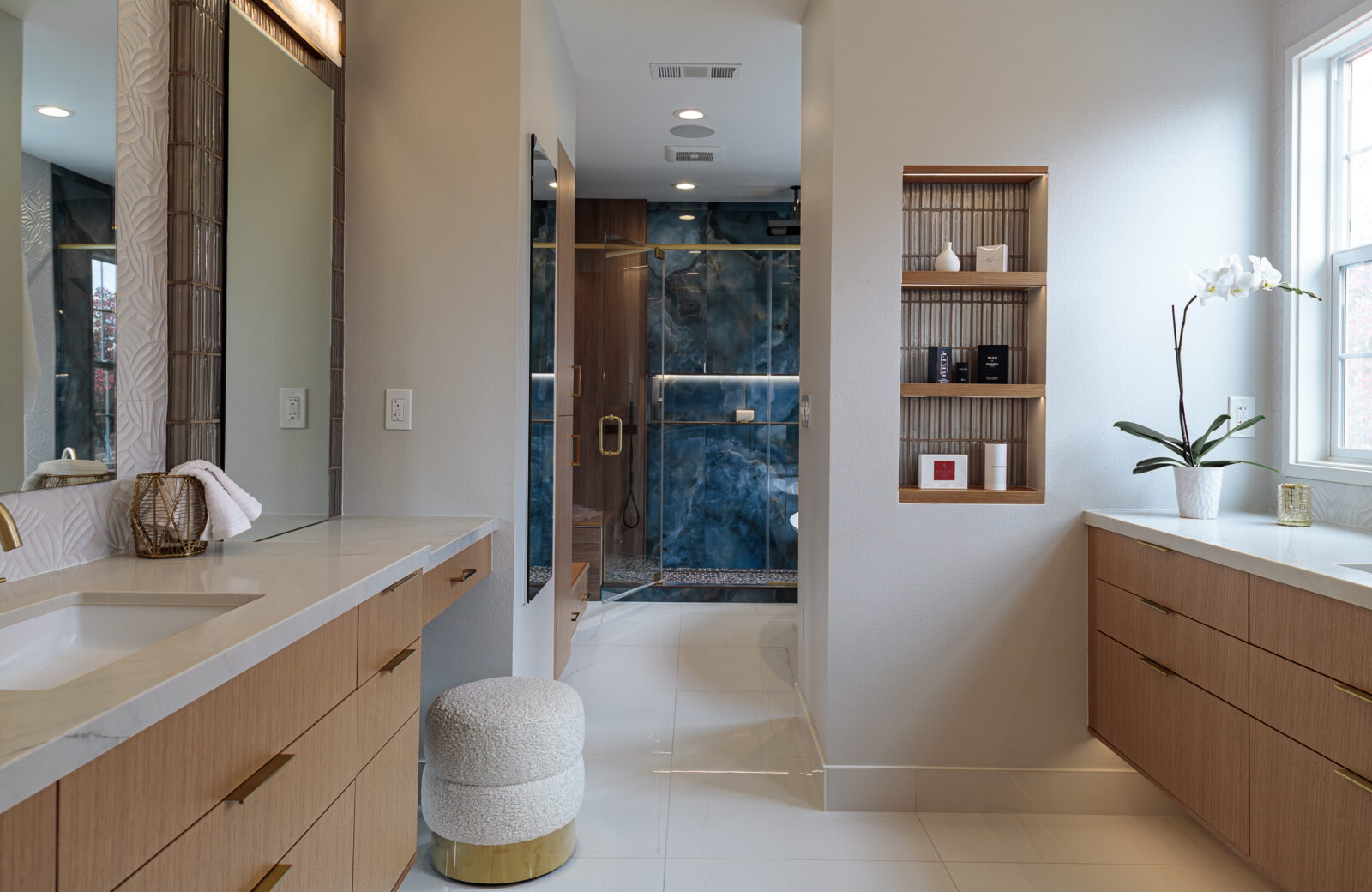 primary bathroom shower with large format blue tile, linear drain