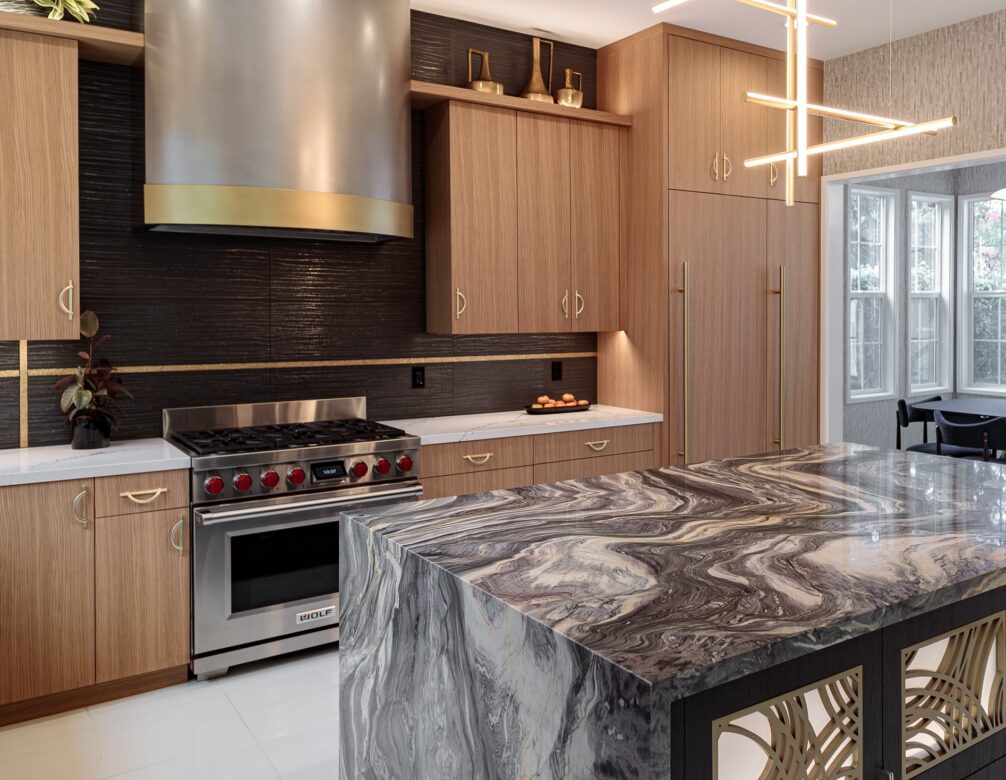 black tile backsplash around a custom metal hood, with accent tile
